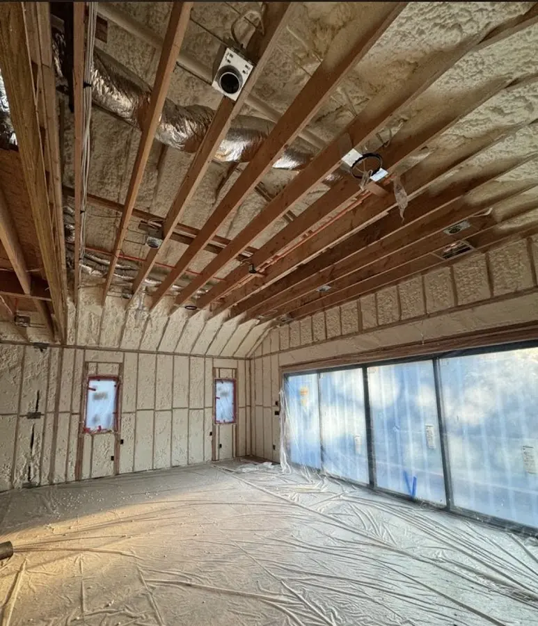 Interior walls and ceiling insulated with spray foam during new construction in East Goshen
